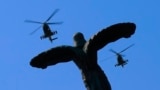 ROMANIA -- A formation of two military attack helicopters IAR 330 Puma SOCAT belonging to the Romanian Air Force fly over the Statue of Air Heroes during a ceremony marking the Aviation Day and Air Force Day, in Bucharest, Romania, 20 July 2023.