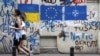 Graffiti on a wall in the old town of Tbilisi depicts the Ukrainian, EU, and NATO flags on May 23.