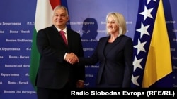 Hungarian Prime Minister Viktor Orban (left) shakes hands with Borjana Kristo, Chairwoman of Bosnia's Council of Ministers, in Sarajevo on June 22.