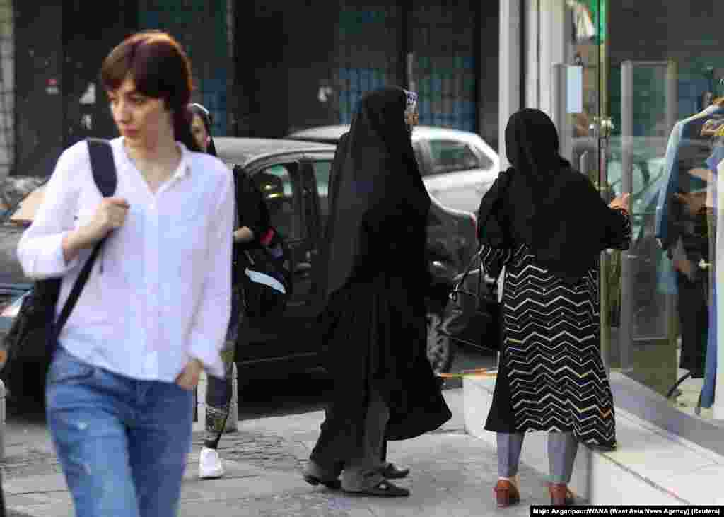 Contrasting clothing styles seen in Tehran on July 16.&nbsp; Shortly after the July 16 announcement that the morality police would return to on-the-spot enforcement, clashes broke out in the northern city of Rasht after they attempted to arrest three women.&nbsp;