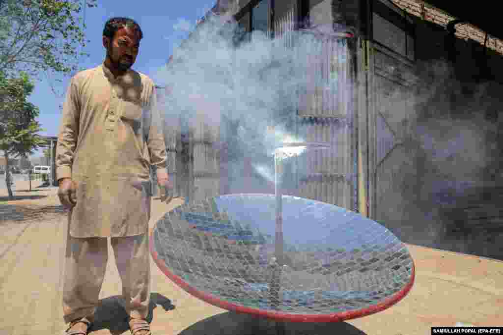 Local blacksmith Ghulam Abbas tests a solar stove that he built at his workshop in Kabul on May 8. The parabola-shaped solar heaters have grown in popularity in Afghanistan as the country is in the grip of a chronic energy crisis.