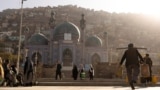 People walk around the Sakhi Shah-e Mardan Shrine in Kabul. The shrine is visited mainly by Hazaras, a Shi'ite community.
