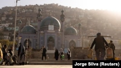 People walk around the Sakhi Shah-e Mardan Shrine in Kabul. The shrine is visited mainly by Hazaras, a Shi'ite community.
