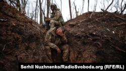 Ukrainian soldiers take a rest near Bakhmut, Donetsk region, in May.