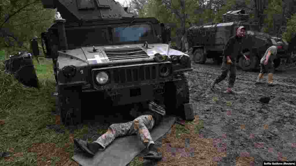 Members of a Ukrainian maintenance battalion repair a U.S.-made Humvee vehicle at an undisclosed location near the front on July 20.