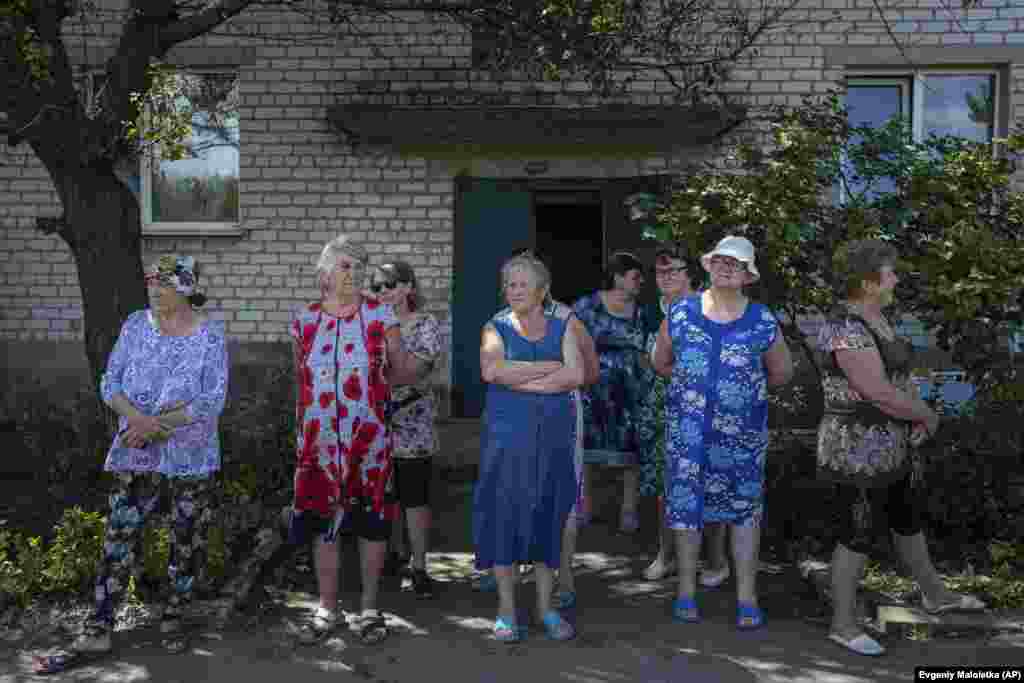 Women wait to receive humanitarian aid in Cherkasky, Ukraine.