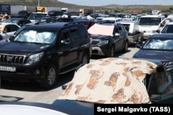 Vehicles lie stranded by the Kerch Strait on July 17 after ferry services were suspended.
