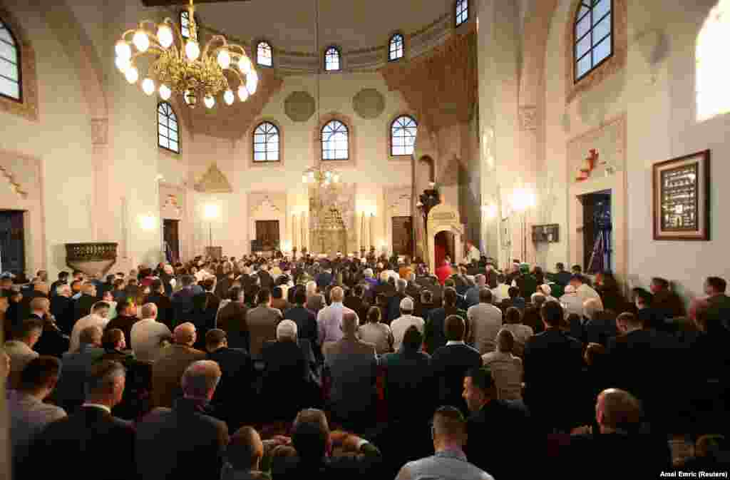 Bosnian Muslims pray during the first day of Eid al-Fitr at the Begova Mosque in Sarajevo.