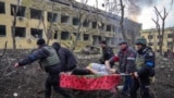 Iryna Kalinina, an injured pregnant woman, is carried from a maternity hospital that was damaged during a Russian air strike in Mariupol, Ukraine, on March 9, 2022. Her baby, named Miron (after the word for &quot;peace&quot;), was stillborn, and half an hour later Iryna died as well.<br />
<br />
World Press Photo of the Year:<em> </em>Mariupol Maternity Hospital Airstrike by&nbsp;Evgeniy Maloletka, AP