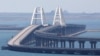 A train moves along the Crimea bridge, a section of which was damaged by an alleged attack the night before, on July 17.