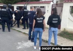 Romanian police search a care home earlier this month.