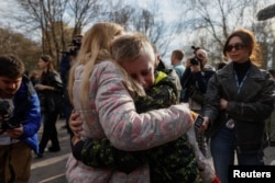 Iryna embraces her 13-year-old son, Bohdan, who was taken to Russia after attending a Russian-organized children's camp.