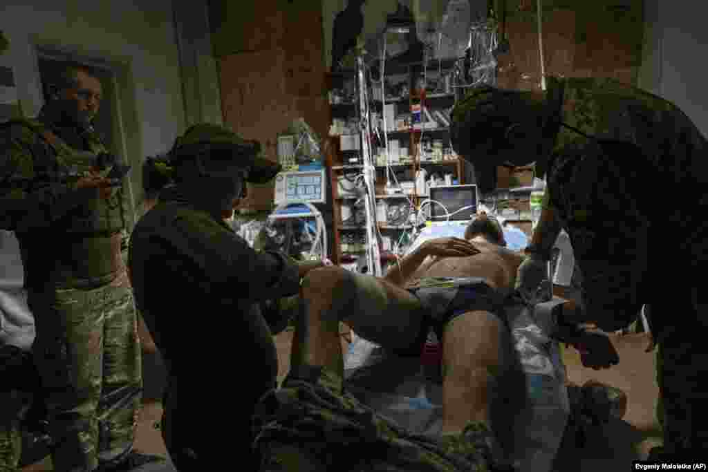 Military medics treat an injured Ukrainian soldier in the field hospital near Bakhmut on July 12. Both sides have refused to disclose casualty figures. &nbsp;