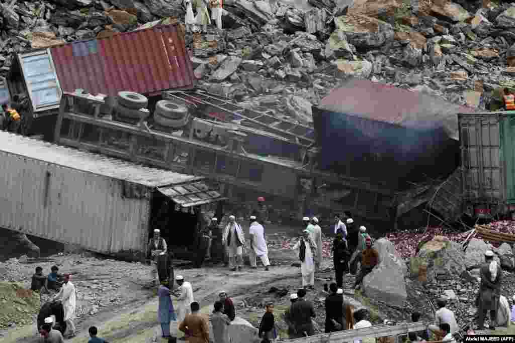 Rescuers work at the site of a landslide in northwestern Pakistan near the Torkham border crossing with Afghanistan on April 18. At least two people died in the incident as dozens of trucks that that were waiting to cross the border were buried under the rubble.&nbsp; Officials say the massive landslide was triggered by lightning amid heavy rains.