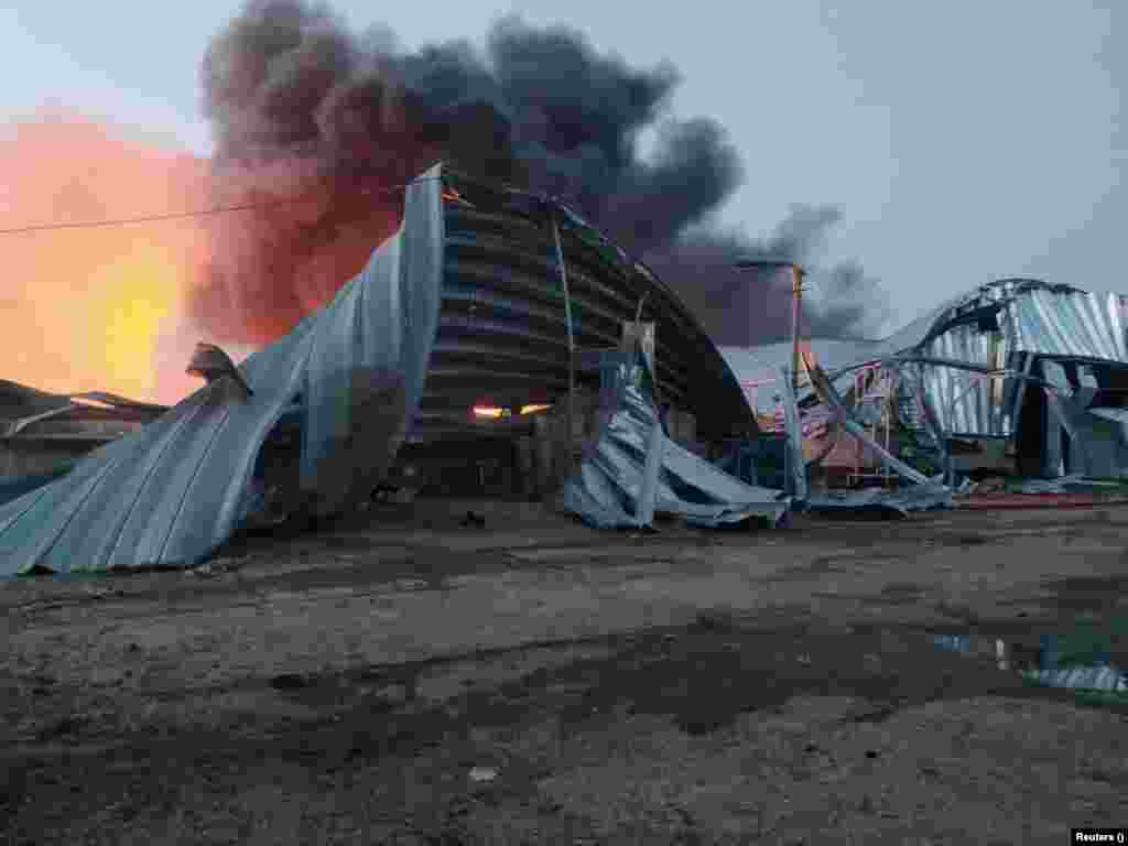 A grain warehouse burns following a Russian missile attack in Odesa on July 21. It was the fourth day of Russian missile strikes on Ukrainian Black Sea port installations, destroying a large amount of food stored for export.