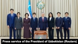 Uzbek President Shavkat Mirziyoev (center) and his family members pose during the early presidential election in Tashkent on July 9.