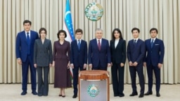 Uzbek President Shavkat Mirziyoev (center) and his family members pose during the early presidential election in Tashkent on July 9.