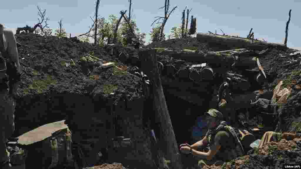 A Ukrainian soldier rests in a recently captured trench near Bakhmut.
