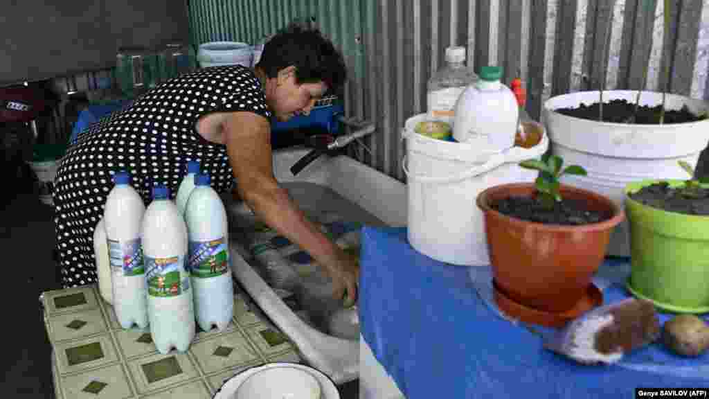 Polyakova stores homemade milk products in a bathtub to preserve them from the hot weather in her damaged house. &quot;But we have already conquered our worst fears. Maybe it&#39;s because we have simply grown used to (the war),&quot; she said.