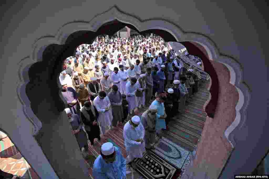Pakistani Muslims attend the last Friday congregational prayers, on the eve of Eid al-Fitr, of the fasting month of Ramadan, in Peshawar. Pakistan.