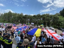 Supporters march in support of Saakashvili near the clinic where he has been receiving medical treatment in Tbilisi on June 3.