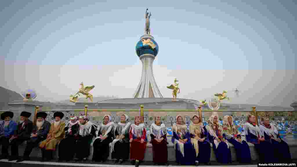 People dressed in traditional attire wait for the start of the ceremony. The vast majority of Turkmenistan&#39;s citizens live in poverty, despite the country&#39;s abundant natural gas resources.