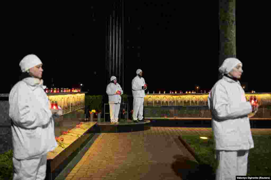 Chernobyl staff hold candles at the memorial in&nbsp;Slavutych.&nbsp;In the immediate aftermath of the disaster, 31 people lost their lives, but it&#39;s estimated that tens of thousands of people have ultimately died of radiation-related illnesses.