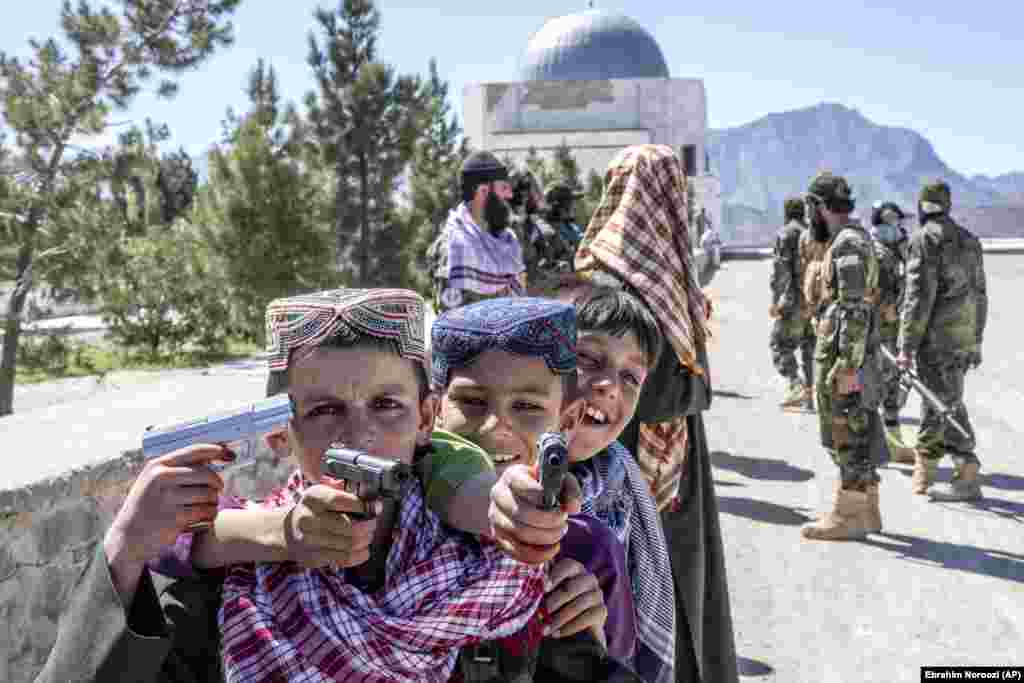 Afghan children play with toy guns during the first day of Eid al-Fitr in Kabul.