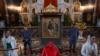 A Russian Orthodox believer bows before Andrei Rublev's Trinity icon on exhibit at the Christ the Savior Cathedral in Moscow in June.