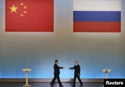 President Vladimir Putin (right) and his Chinese counterpart, Xi Jinping, in Moscow in March 2013 during Xi's first foreign trip as leader.