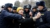 Police detain an RFE/RL journalist covering a protest near the government building in Bishkek in January.