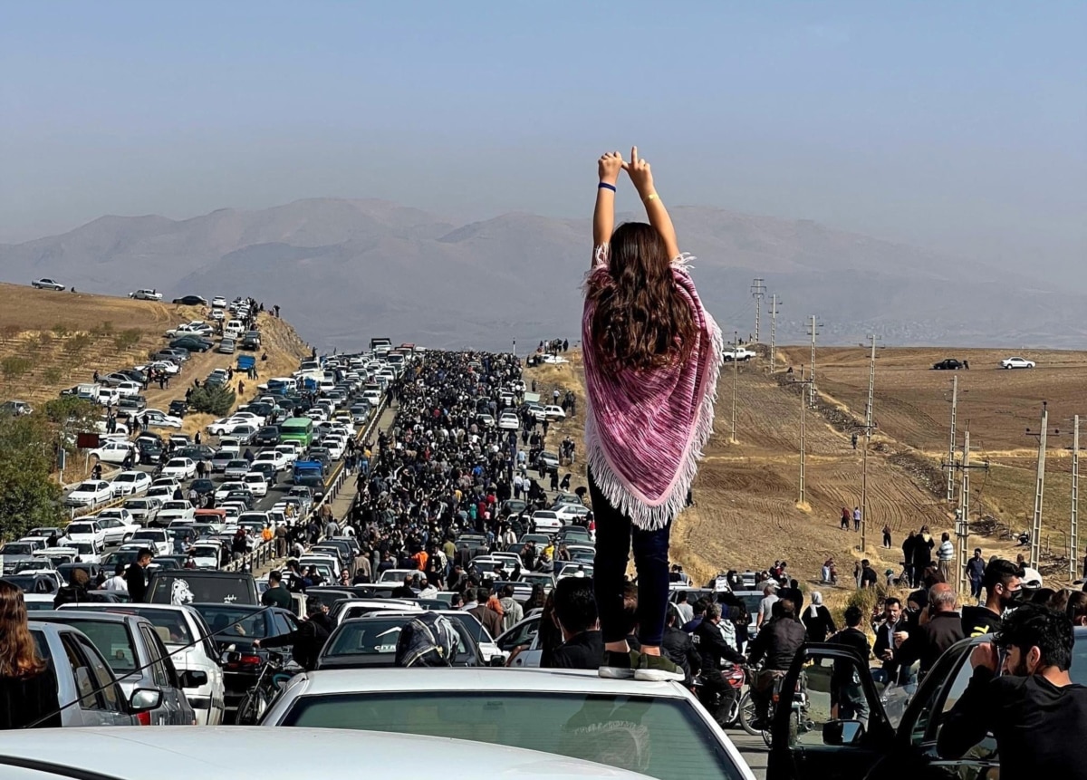 Thousands of Iranians, including this defiant unveiled woman, make their way toward the Aichi cemetery in Saqhez, Mahsa Amini's hometown in the western Iranian province of Kurdistan, to mark 40 days since her death.