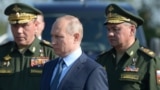 Russian President Vladimir Putin (center) visits a flight-test center in the Astrakhan region in 2019 with Chief of the General Staff Valery Gerasimov (left) and Defense Minister Sergei Shoigu.