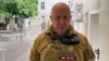 A video grab from handout footage posted on June 24 shows Yevgeny Prigozhin speaking inside the headquarters of the Russian southern military district in the city of Rostov-on-Don. 