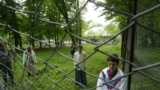 Female residents of a maximum-security psychiatric hospital look through a fence in Romania, where a lack of understanding and discrimination against people with mental illness is still rife. (illustrative photo)