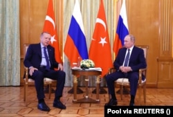 Putin listens to Erdogan during a meeting in Sochi, Russia, on August 5, 2022.
