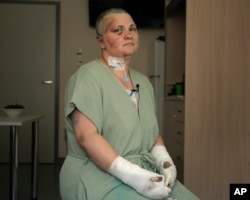 Yelena Milashina sits after receiving medical treatment in Moscow on July 5.