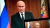 Russian President Vladimir Putin is seen on monitors as he addresses the nation in Moscow on June 24 after Yevgeny Prigozhin, leader of the Wagner private mecernary group, called for armed rebellion and reached the southern city of Rostov-on-Don with his troops.