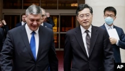 Chinese Foreign Minister Qin Gang (front right) walks with Russian Deputy Foreign Minister Andrei Rudenko (left) in Beijing on June 25, the day China said it "supports Russia in safeguarding national stability and delivering development and prosperity." 