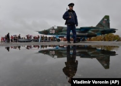 A Russian soldier patrols at Kant, a Russian air base outside Bishkek.