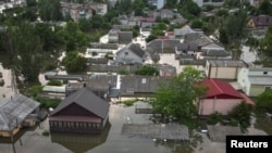 Homes in a flooded area of Ukraine’s Kherson region on June 7, a day after the Kakhovka dam was breached.